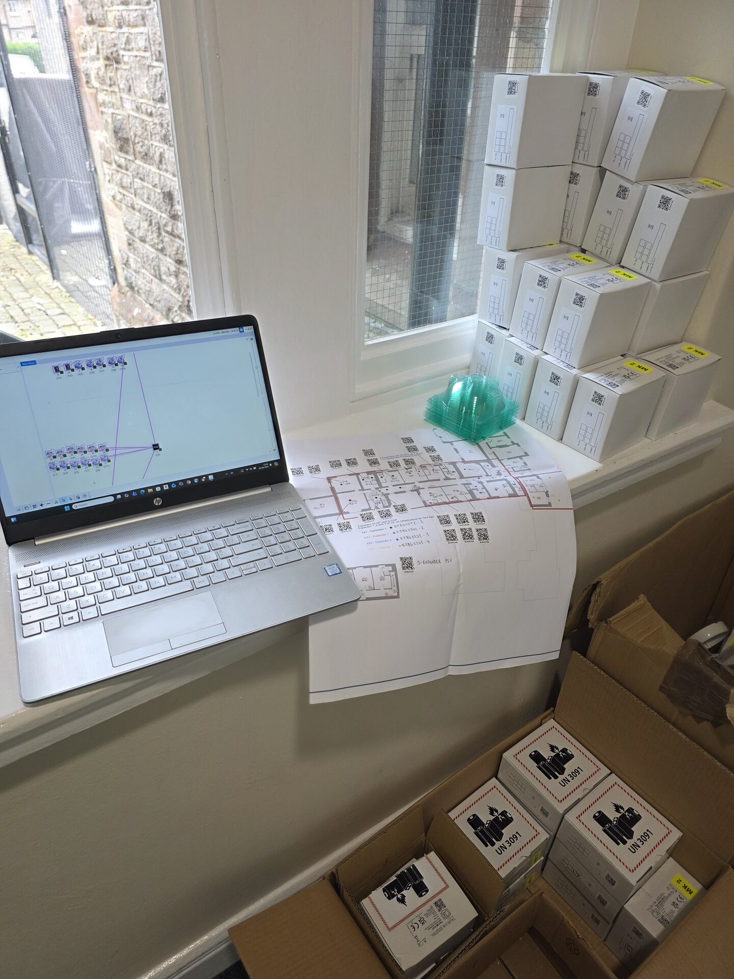 planning a fire alarm system layout on a laptop on site